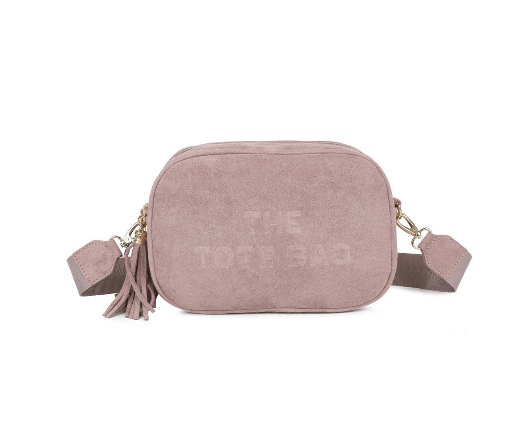 The Tote Bag pink double zip crossbody bag with tassel detail and adjustable strap.
