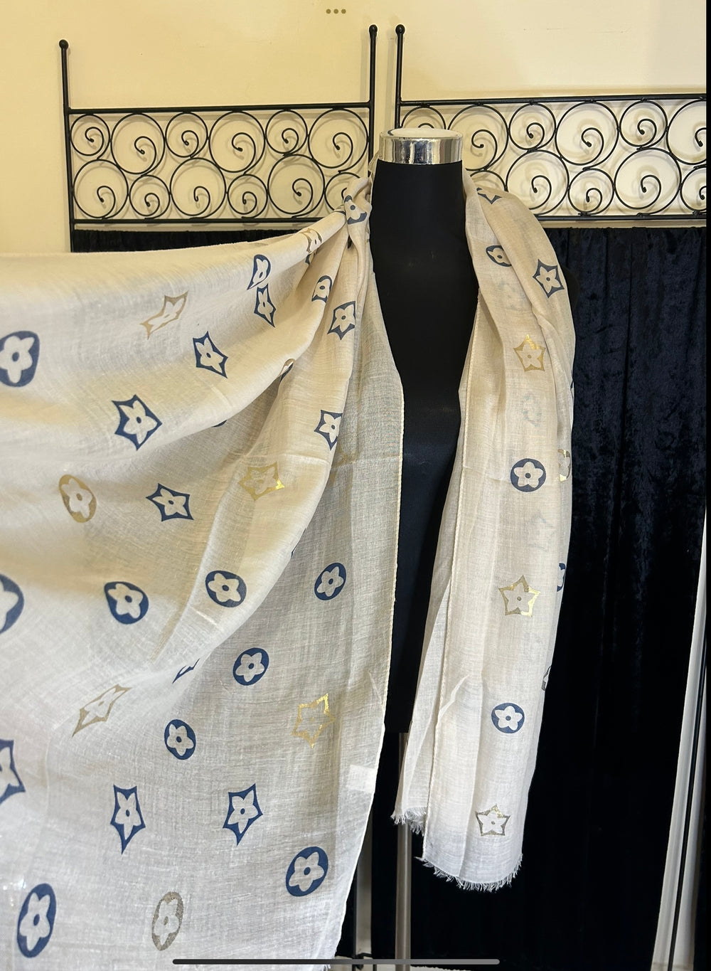 Thin lightweight scarf with flower print design, ideal for spring and summer wear.