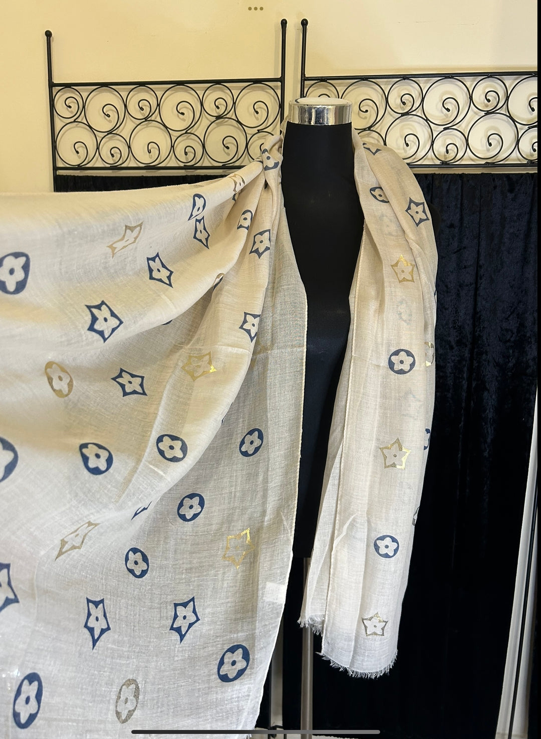 Thin lightweight scarf with flower print design, ideal for spring and summer wear.