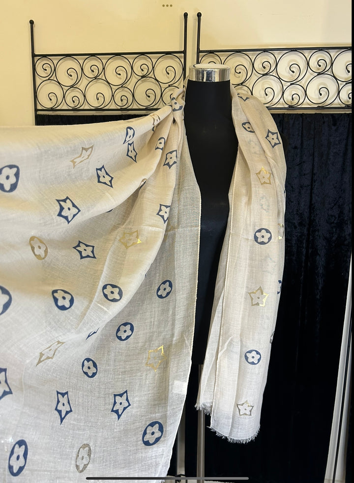 Thin lightweight scarf with flower print design, ideal for spring and summer wear.
