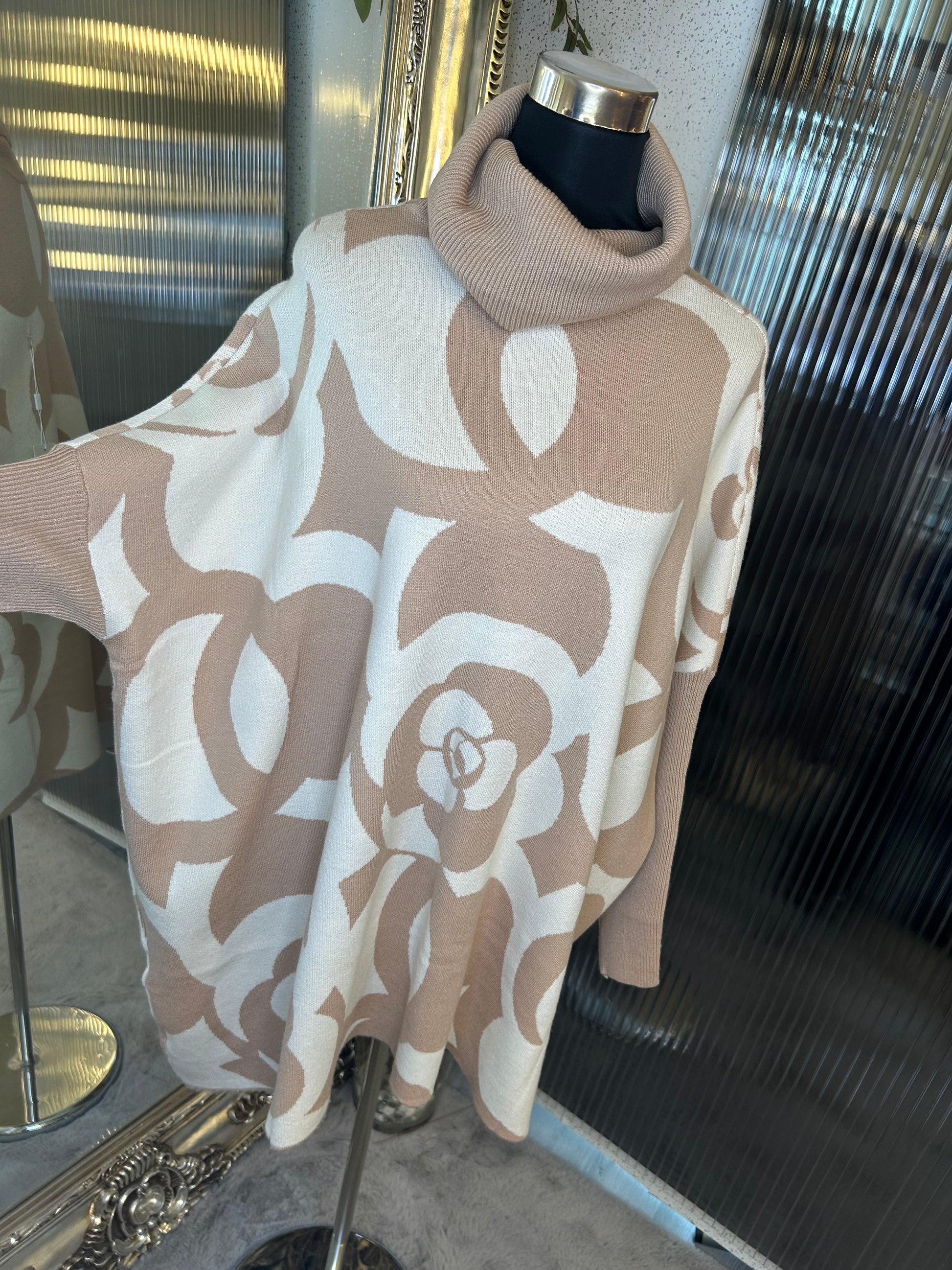 A beige and white floral printed roll neck oversized jumper.