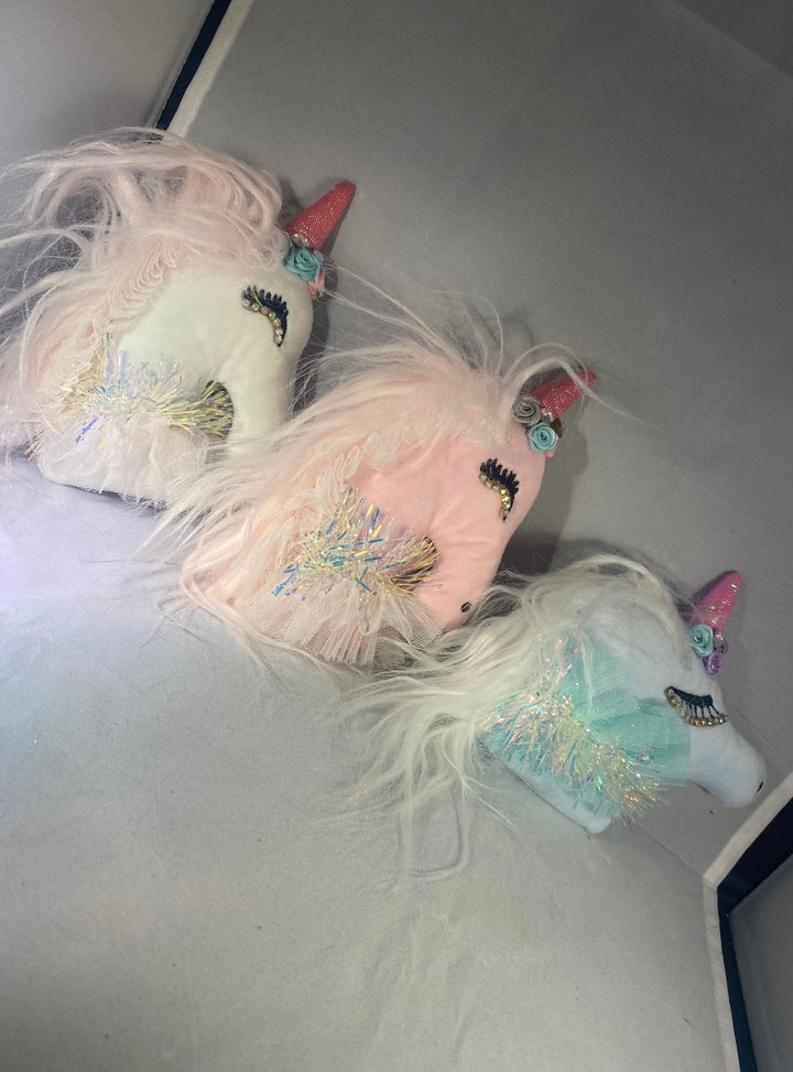 A set of three unicorn-themed key ring chains in pink, white, and blue colors, with glitter and decorative elements.