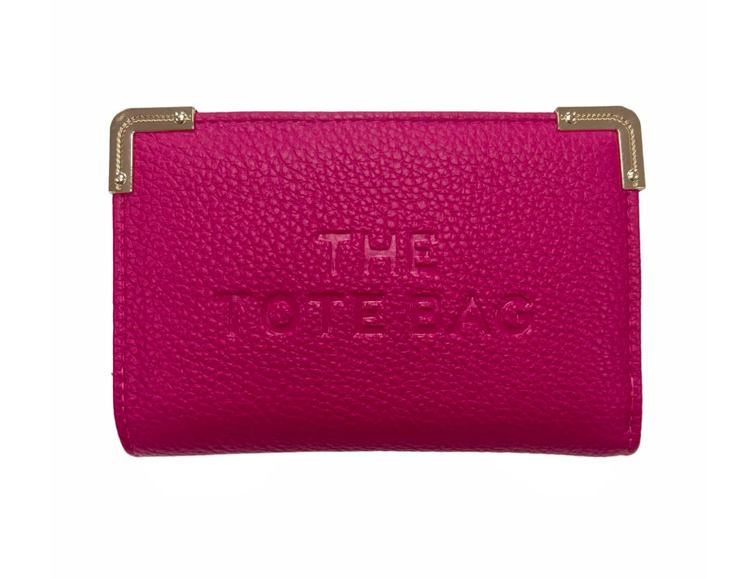 A pink synthetic tote bag with gold tone metal hardware, featuring a fold-over top with a closure, and the ‘THE TOTE BAG&
