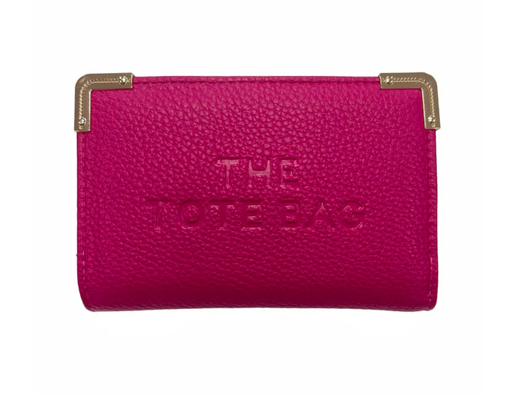 A pink synthetic tote bag with gold tone metal hardware, featuring a fold-over top with a closure, and the ‘THE TOTE BAG&