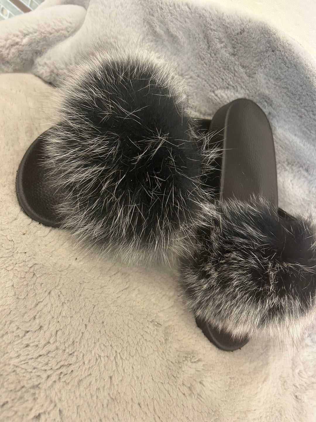 Grey fur sliders with black sole 