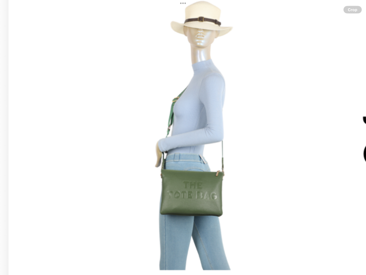 Mannequin wearing a green handbag with &