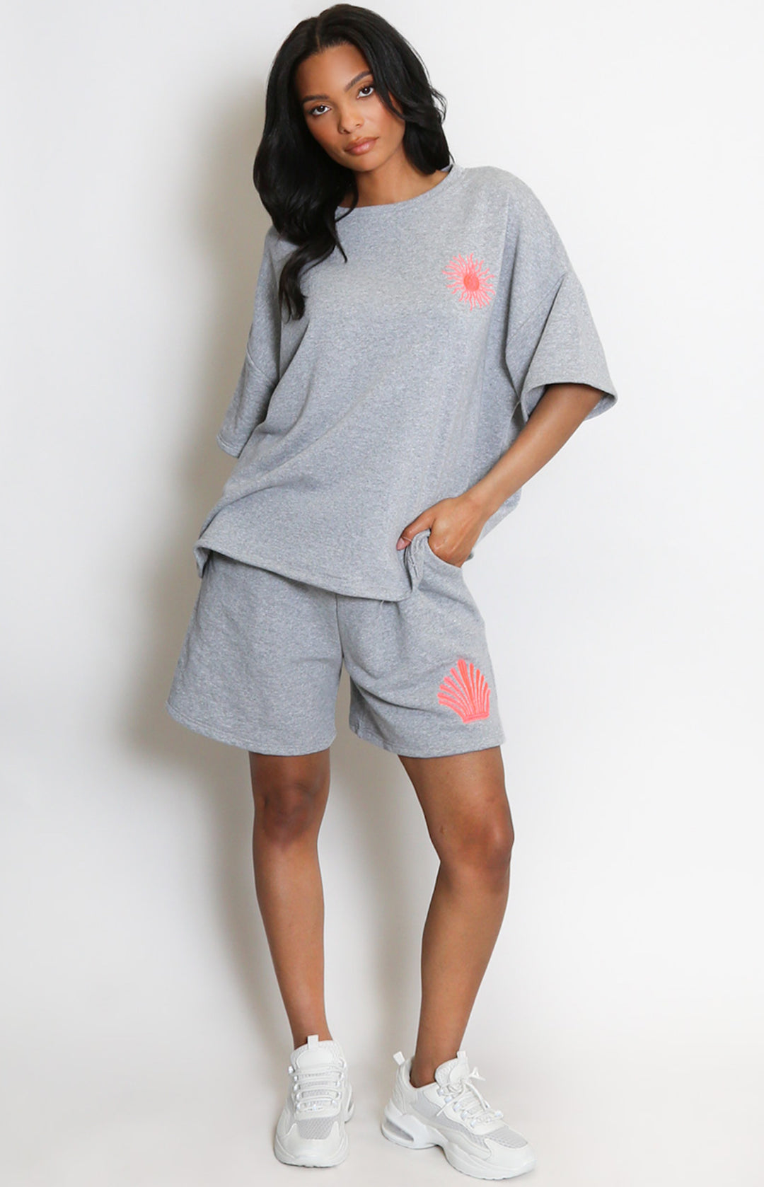  a grey outfit with pink sun designs
