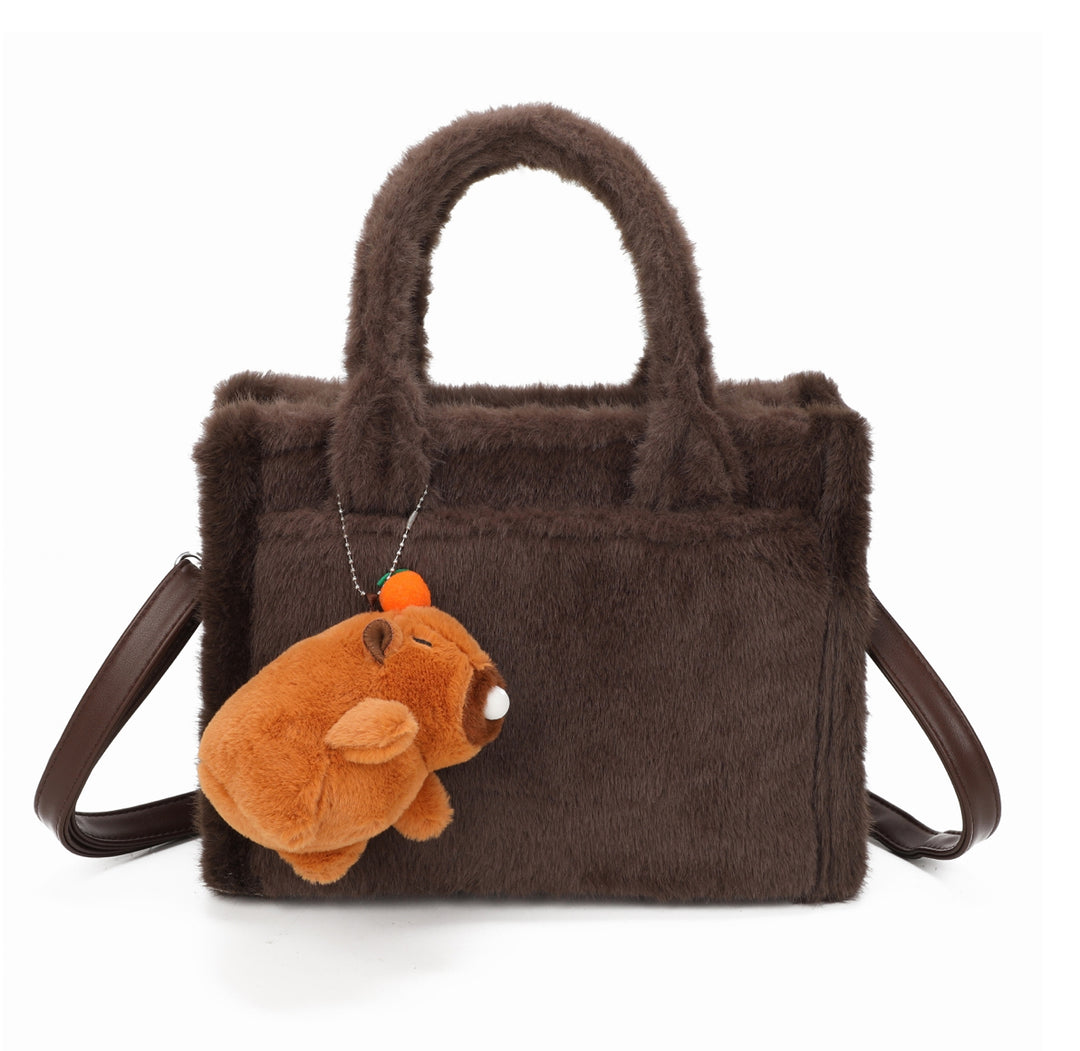 Coffee faux-fur tote bag with a small brown teddy bear keychain and matching handles and strap.