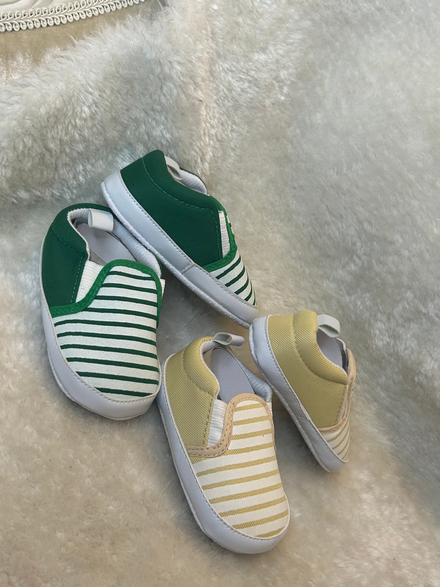 Baby slip-on shoes with striped design, soft white soles with grip dots
