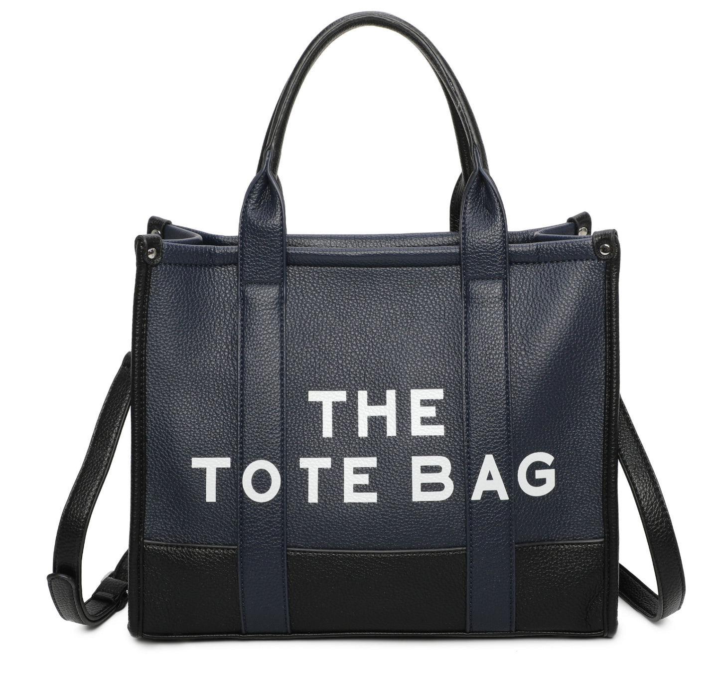 Two tone colour tote bag in navy. Black at the bottom of the bag, white writing stating “the tote bags” displaying a long strap to crossbody the bag.