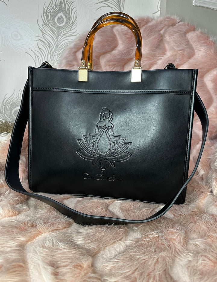 black faux leather tote bag with the cbs logo on the front
