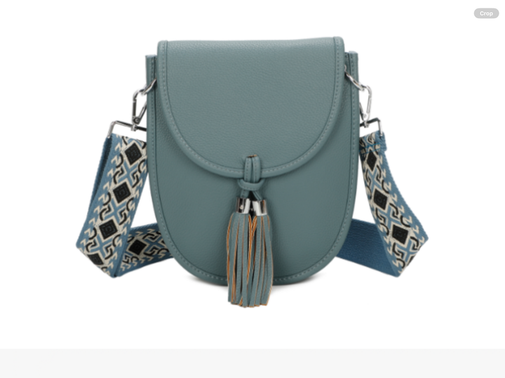 Blue handbag with a decorative strap and tassel 