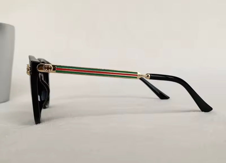 Black sunglasses with gold bee embellishment and green red stripe arms