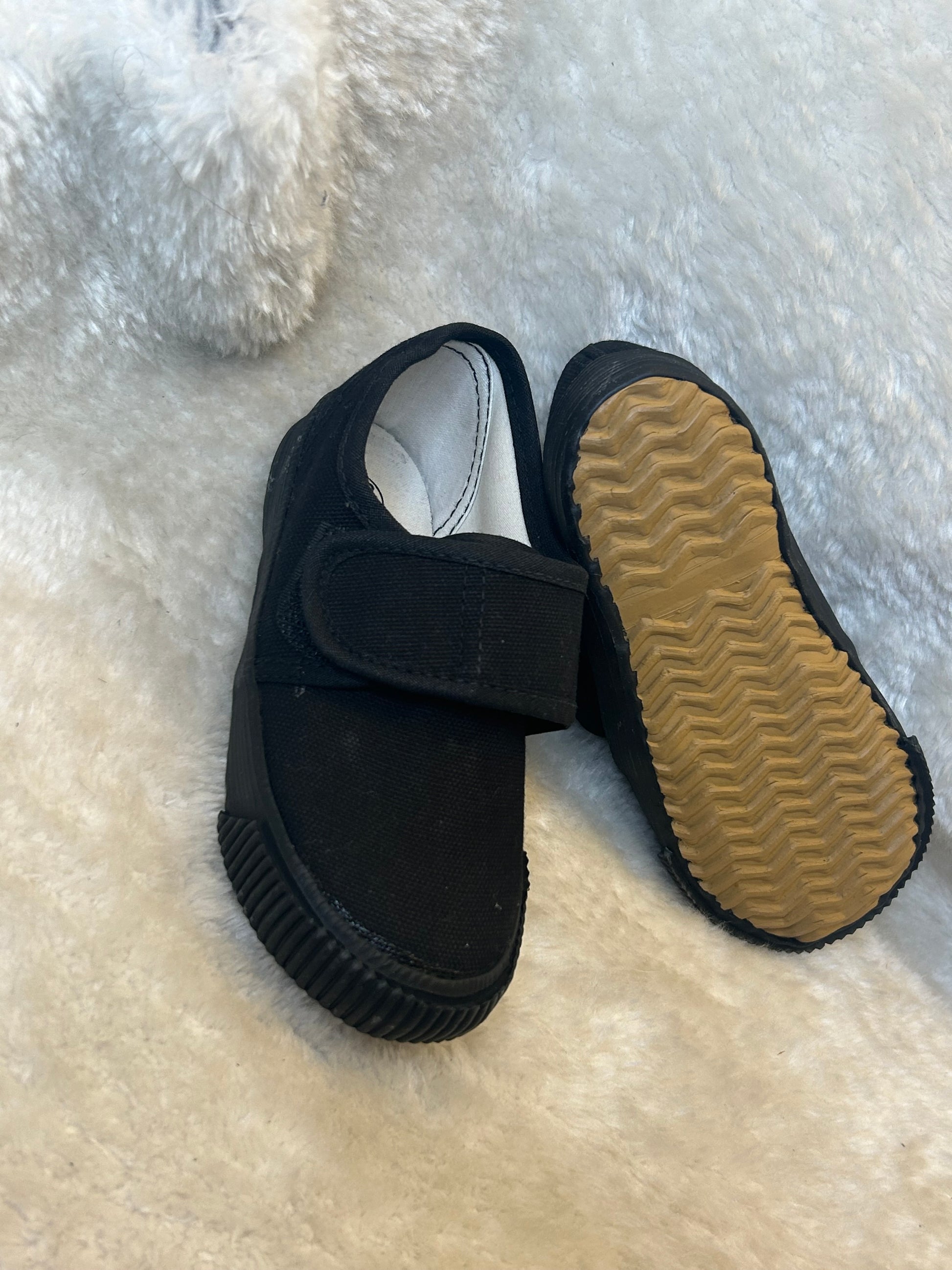 Children’s black canvas shoes with velcro strap and rubber sole
