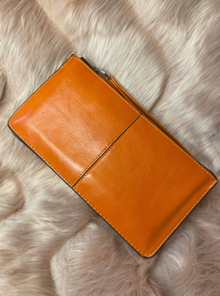 A orange expandable silver detail purse 