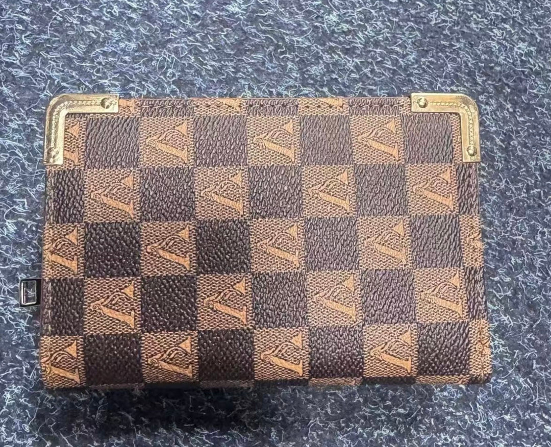 Checkered patterned purse on a textured surface