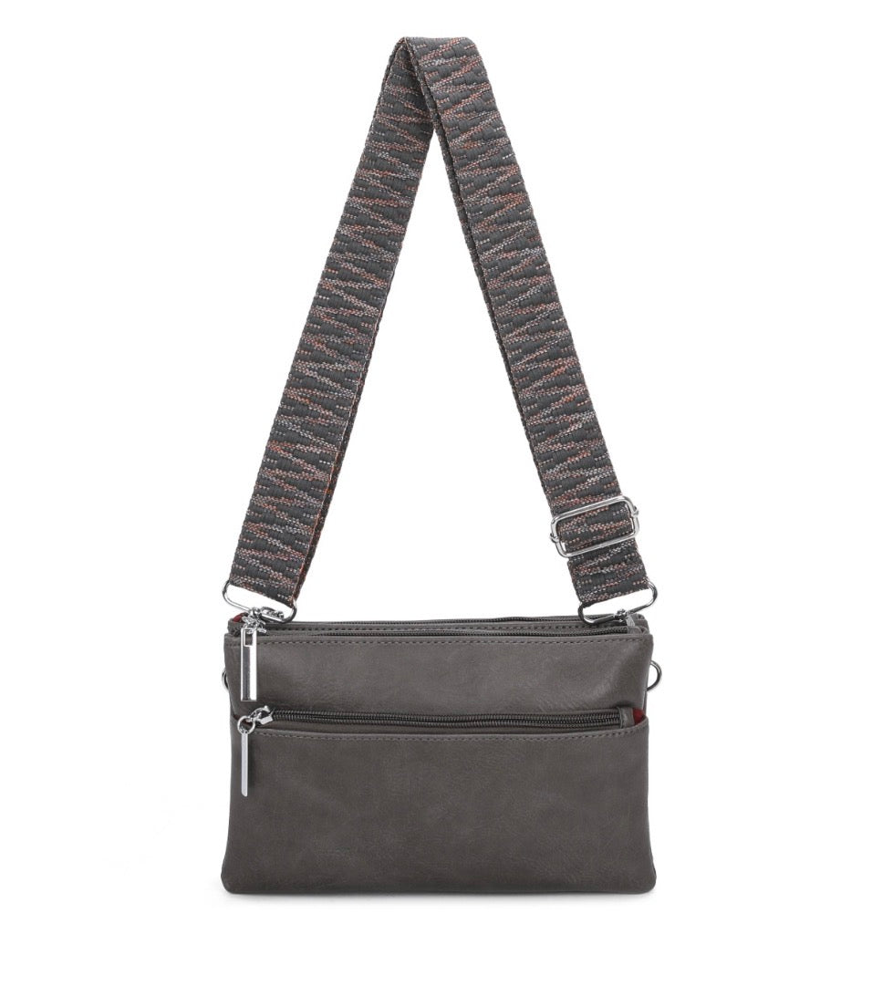 multi pocket crossbody bag with patterned adjustable shoulder strap and silver hardware.