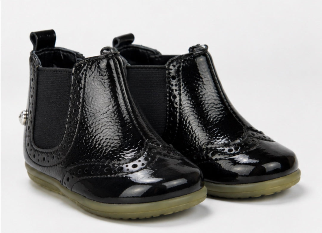 Children’s black patent ankle boots with textured finish, zip fastening and chunky sole