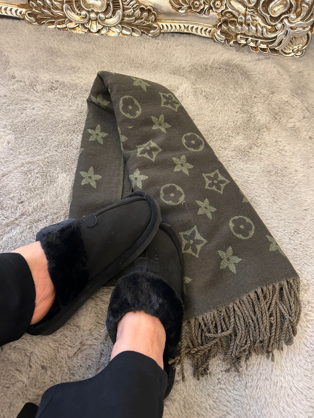 Black slip on slippers with khaki green flower patterned scarf 