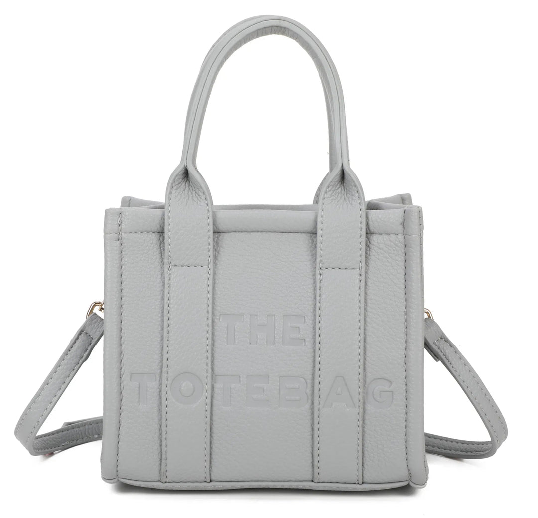 A light grey mini tote bag with &