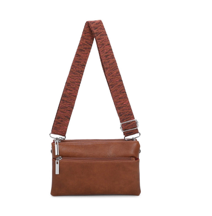 multi pocket crossbody bag with patterned adjustable shoulder strap and silver hardware.