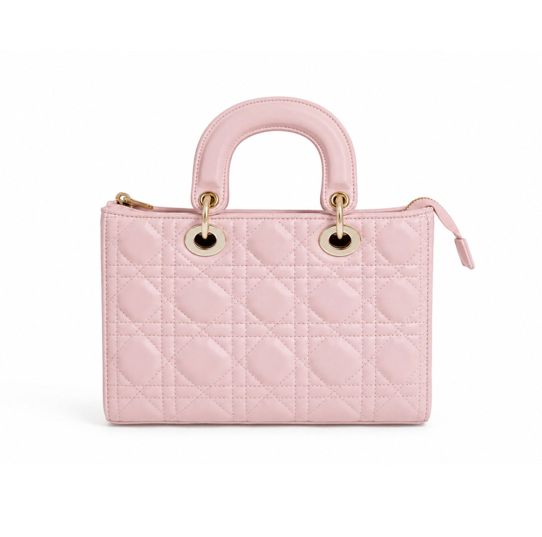 A light pink quilted leather handbag with a top handle, gold-tone hardware, and a zip-around closure, shown against a plain white background.