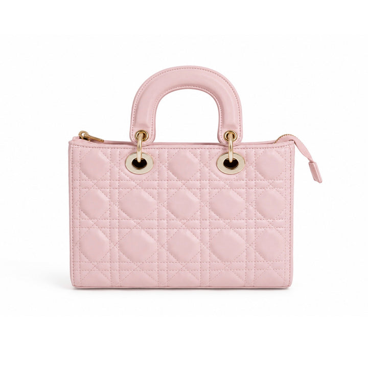 A light pink quilted leather handbag with a top handle, gold-tone hardware, and a zip-around closure, shown against a plain white background.