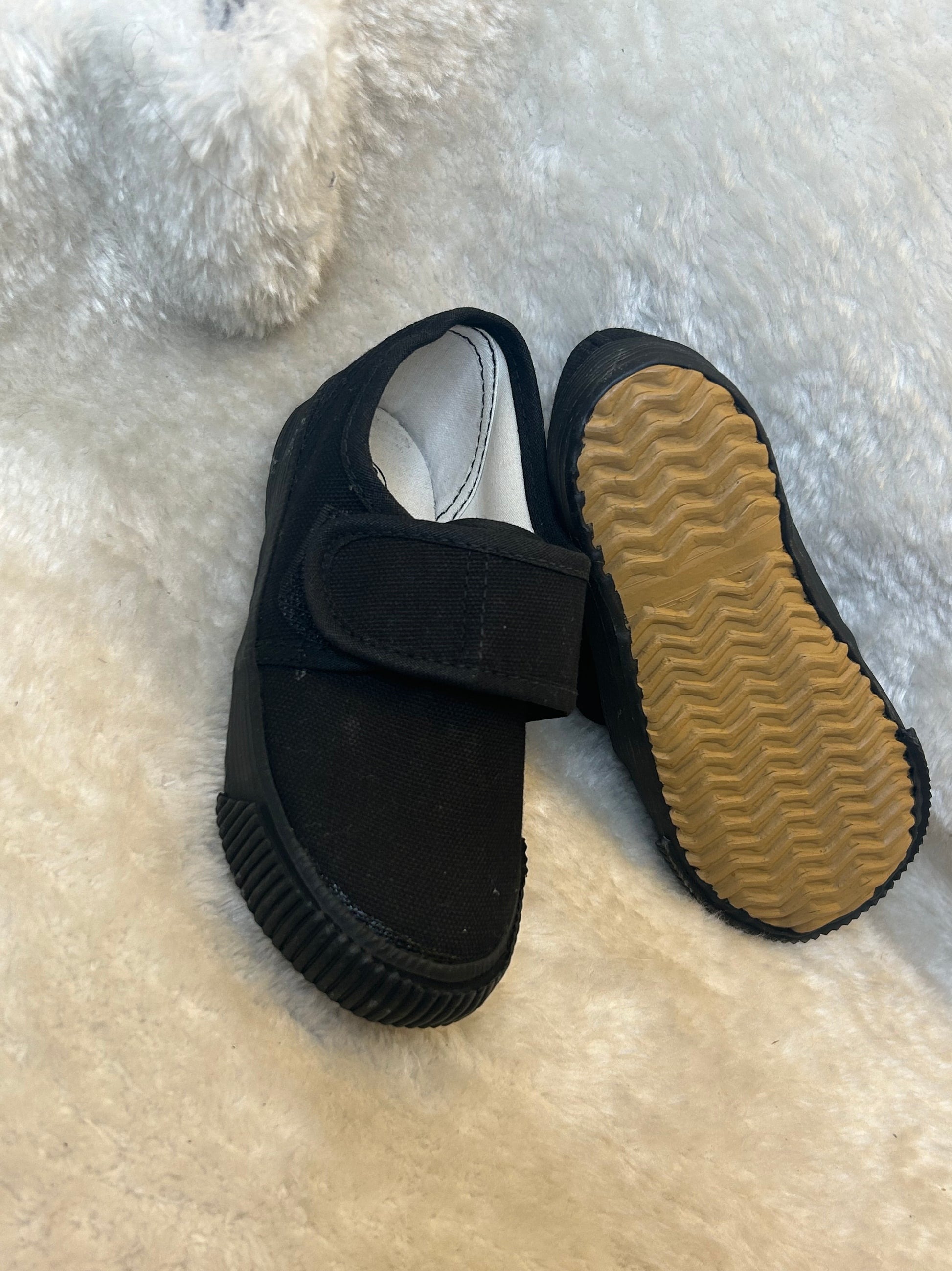 Children’s black canvas shoes with velcro strap and rubber sole