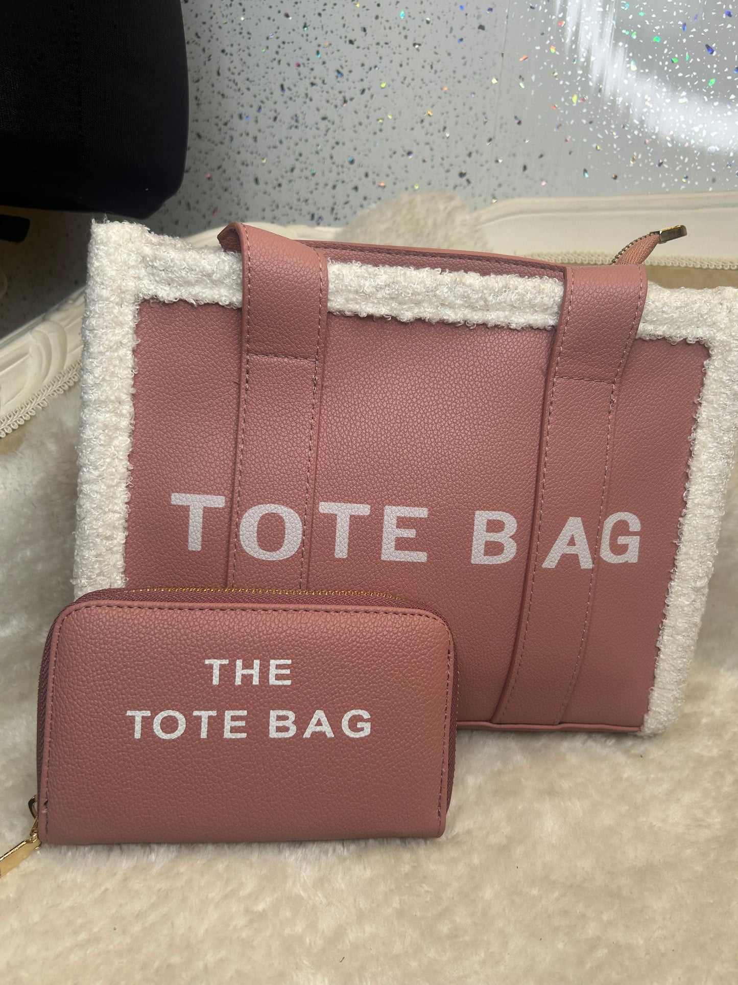 Pink fuzzy tote bags with 'TOTE BAG' text and matching purse 