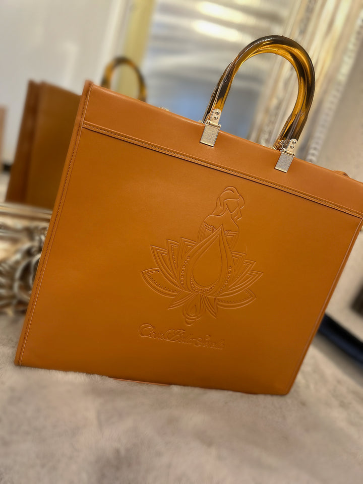 tan faux leather tote bag with the cbs logo on the front