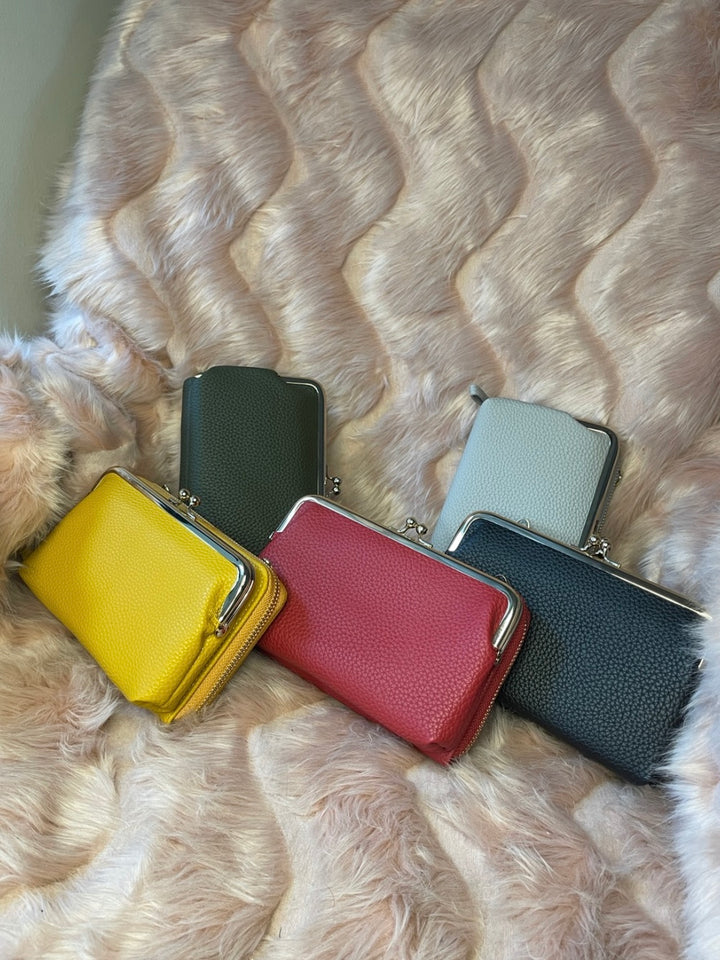 A collection of colourful large size purses with silver detailing 