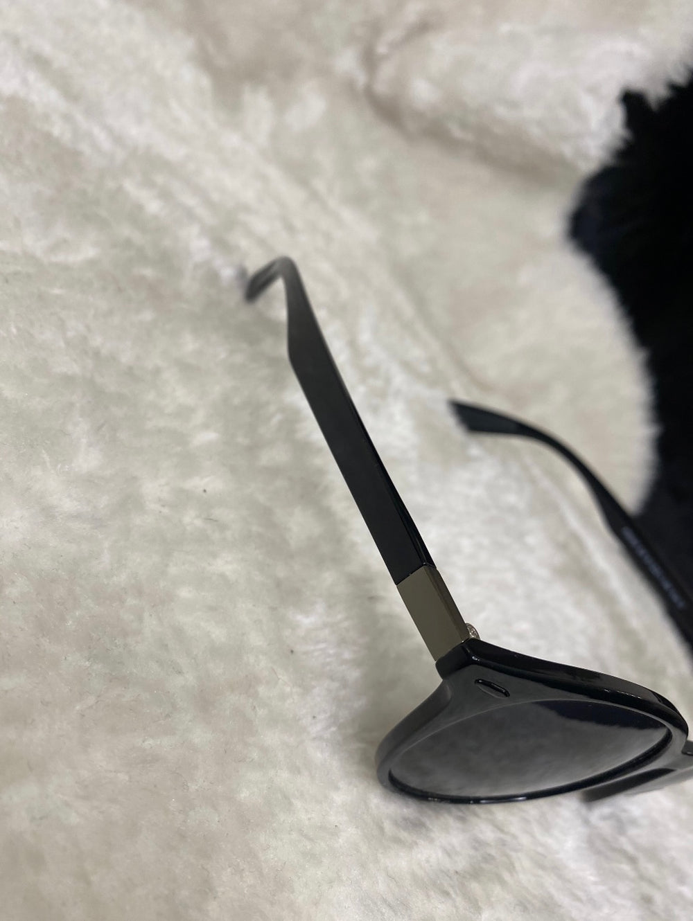A pair of black small unisex sunglasses. 