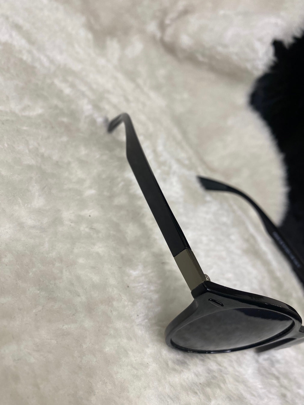 A pair of black small unisex sunglasses. 