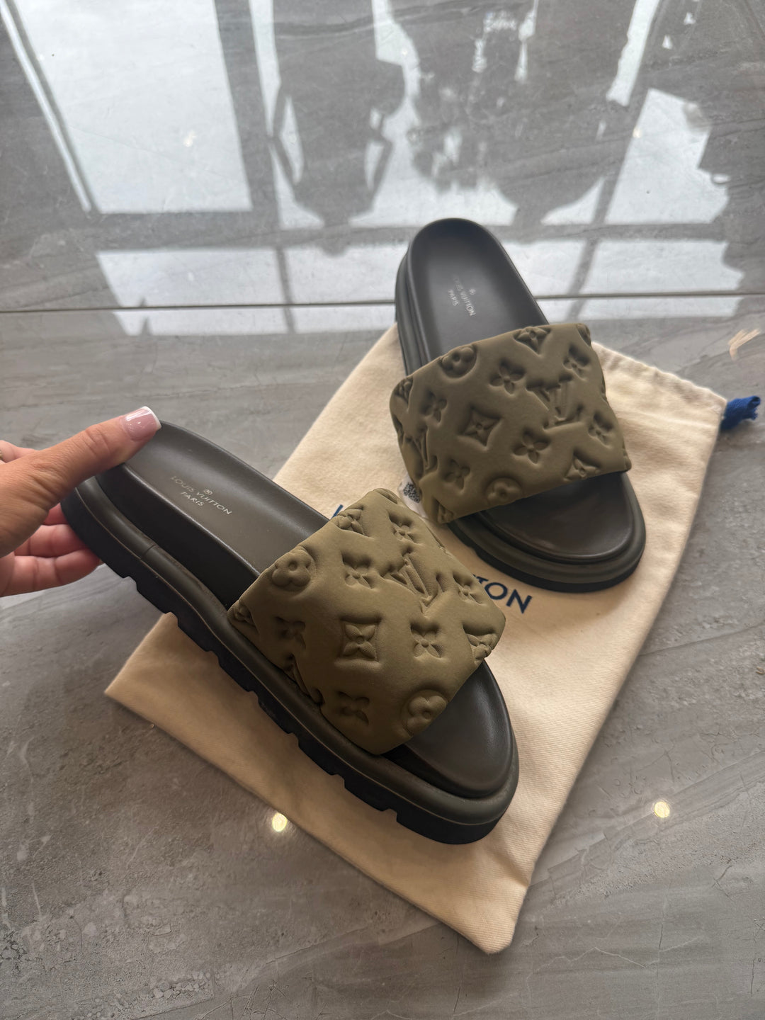 Khaki padded embossed platform sliders with cushioned footbed and chunky sole.