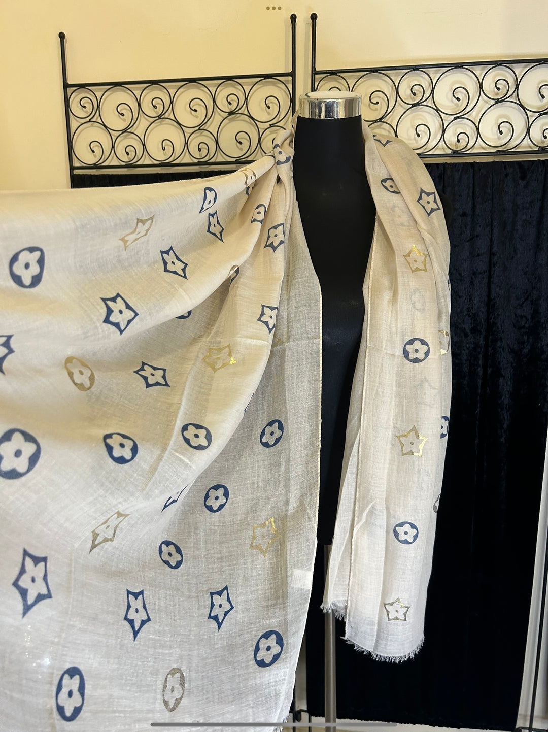 Thin lightweight scarf with flower print design, ideal for spring and summer wear.
