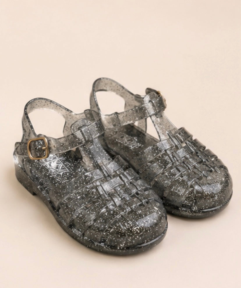 Children’s glitter jelly sandals available in blue and black with buckle ankle straps and flexible sparkly design