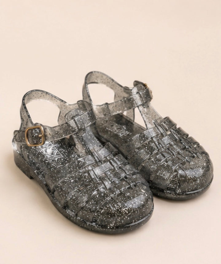 Children’s glitter jelly sandals available in blue and black with buckle ankle straps and flexible sparkly design