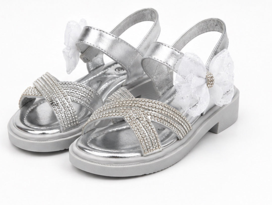 Silver girls’ sandals with sparkling diamanté crossover straps, oversized glitter mesh bow detail 
