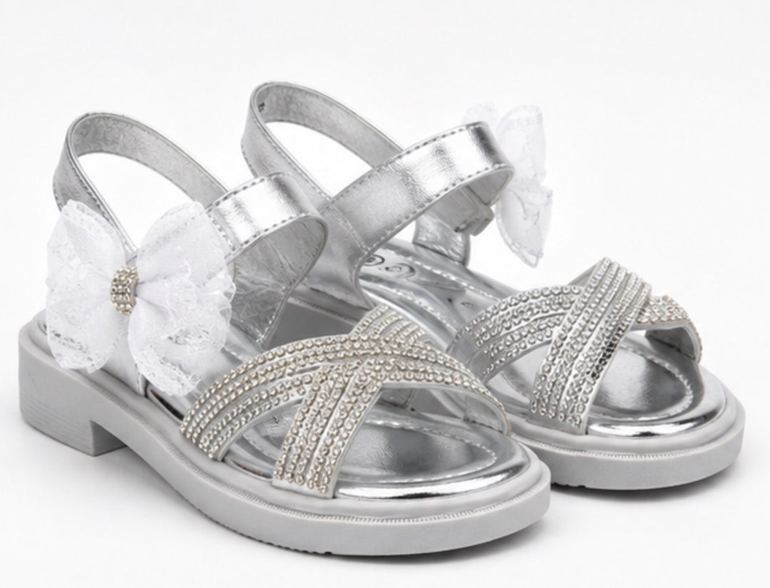 Silver girls’ sandals with sparkling diamanté crossover straps, oversized glitter mesh bow detail 