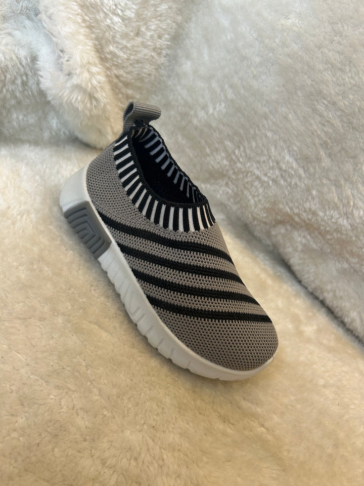 Children’s grey and black slip on trainers with white soles 