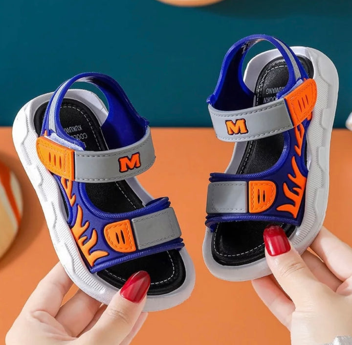 orange sandals for boys with flame detail up the sides of the sandal 