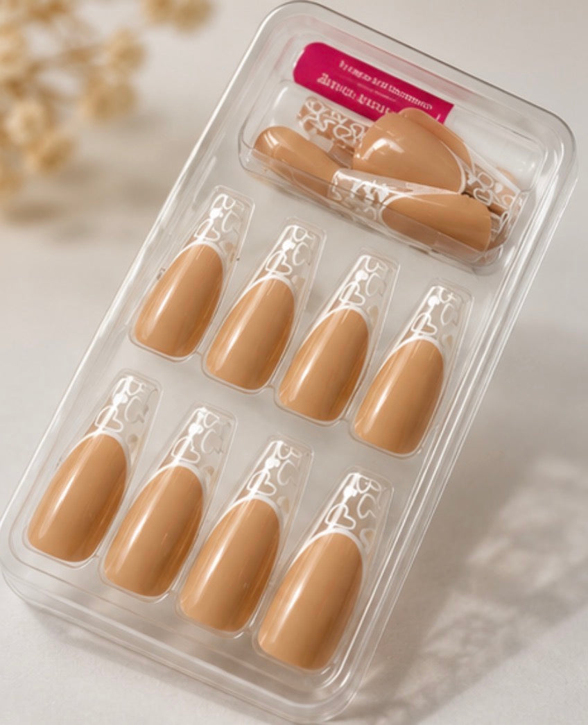 24-piece nude press-on nail set with transparent French tips and white heart detailing