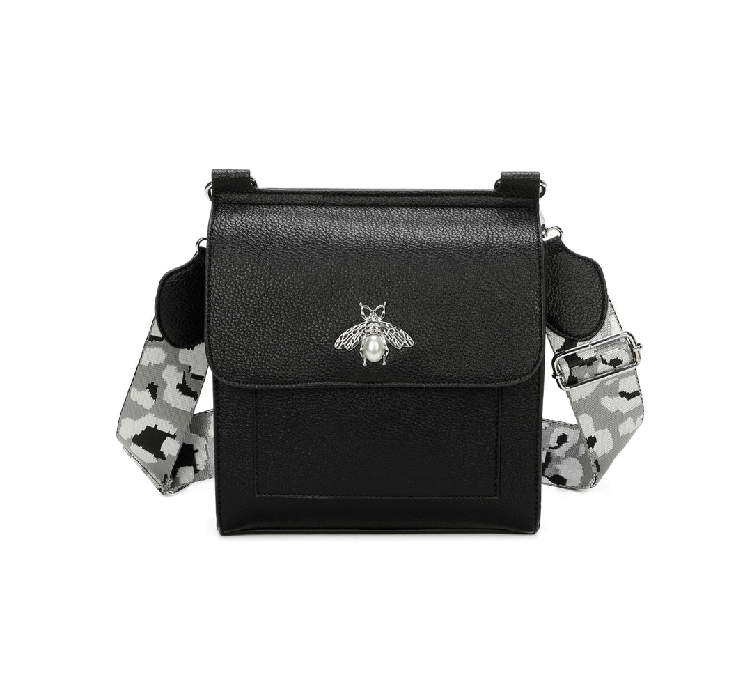 Black crossbody bag with silver bee and pearl detail on flap, adjustable monochrome patterned straw