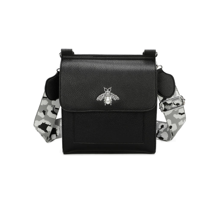 Black crossbody bag with silver bee and pearl detail on flap, adjustable monochrome patterned straw