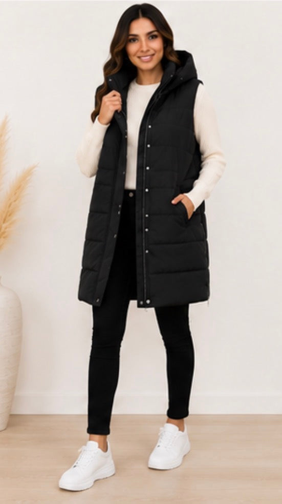Long black padded gilet with hood, quilted design and front zip fastening, sleeveless puffer bodywarmer with pockets