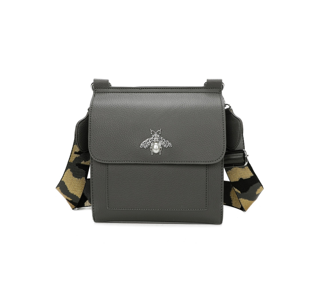 Grey crossbody bag with silver bee and pearl detail on flap, adjustable monochrome patterned straw