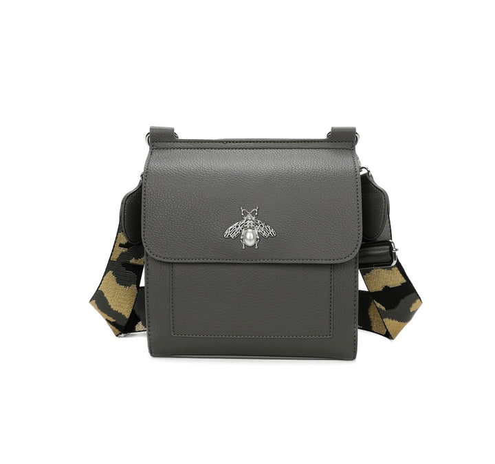Grey crossbody bag with silver bee and pearl detail on flap, adjustable monochrome patterned straw