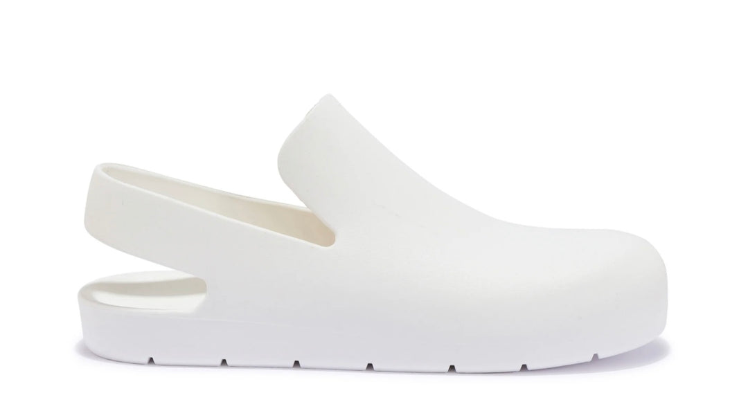 A pair of white slingback clogs 