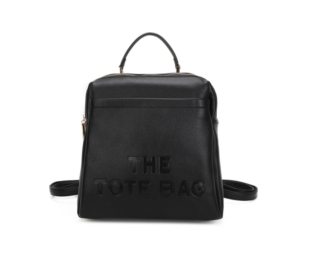 Black rucksack with embossed “ the tote bag” writing on the front 