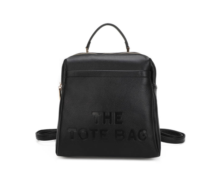 Black rucksack with embossed “ the tote bag” writing on the front 